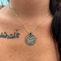 Maori mask coin pendant