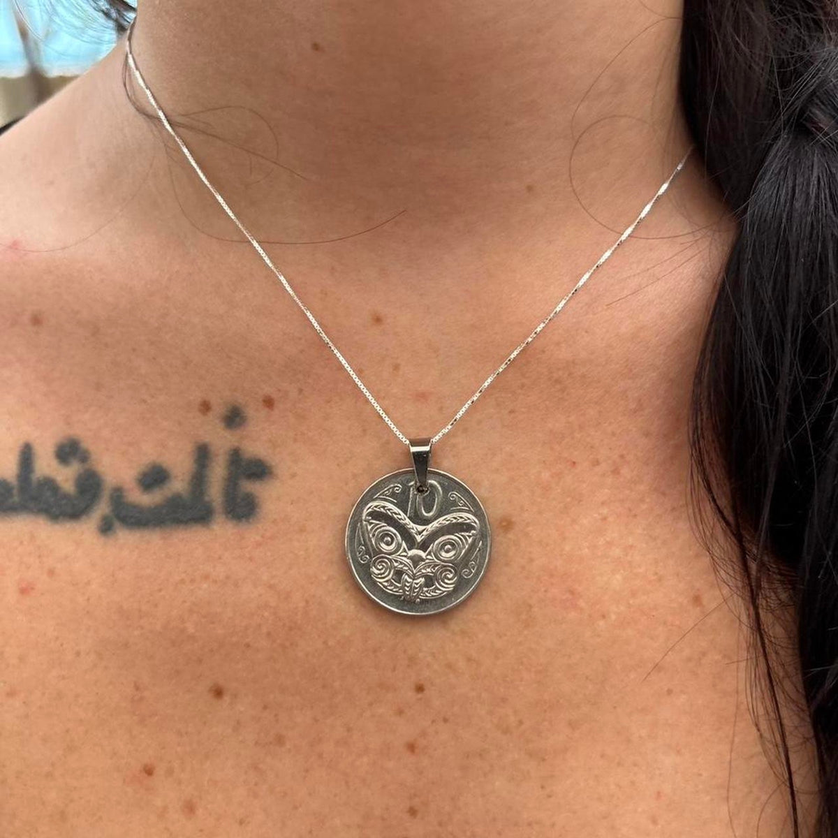 Maori mask coin pendant