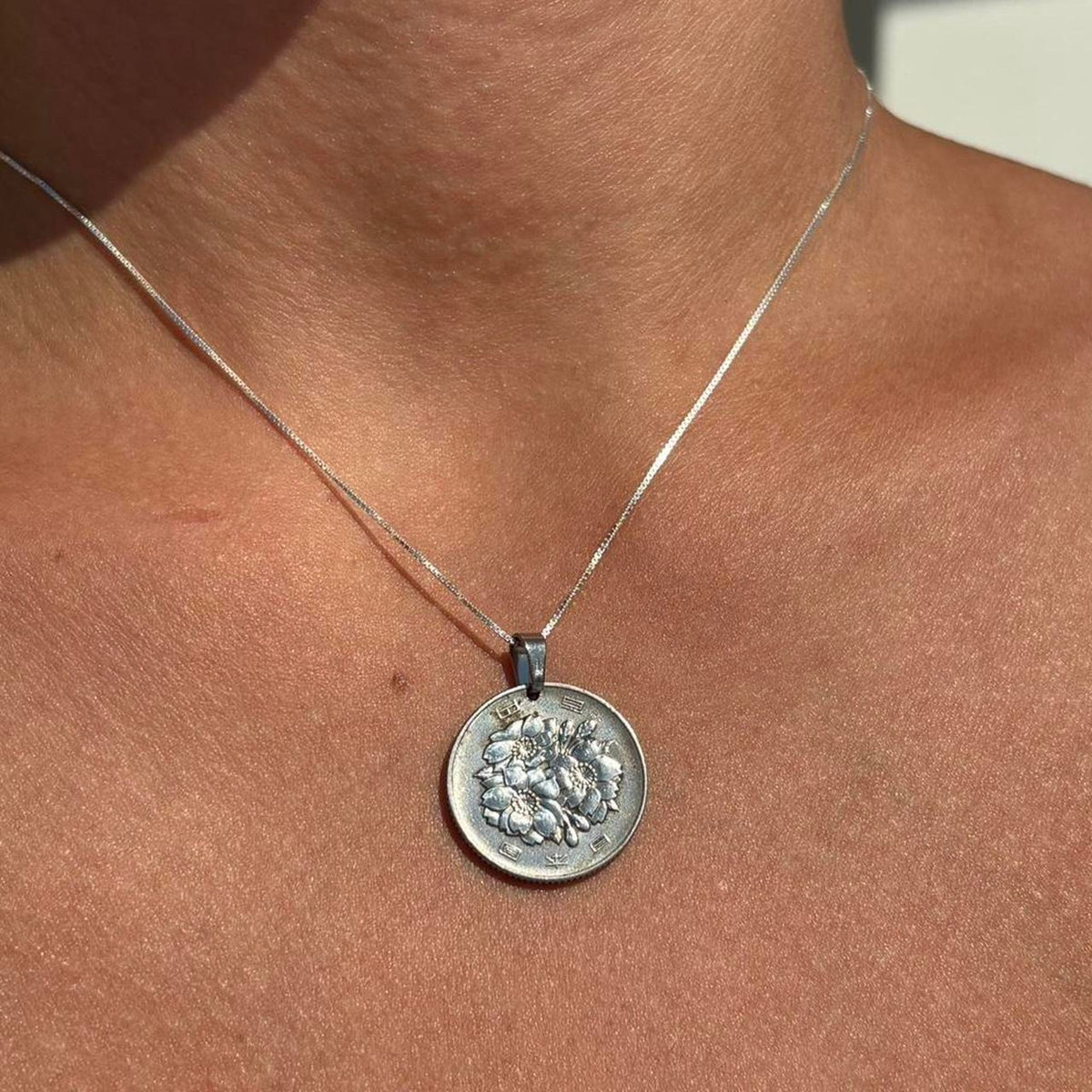 Handmade coin necklace displaying a